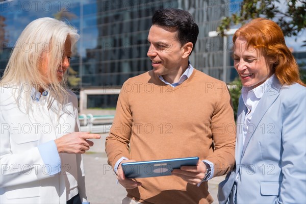 Group executives or businessmen and businesswoman in a business area. looking at the tablet