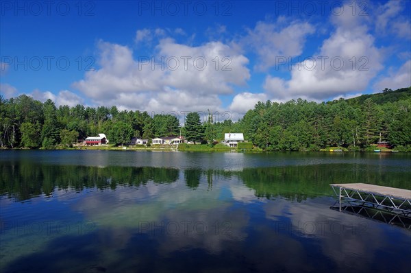 Small lake with bathing jetty and few houses