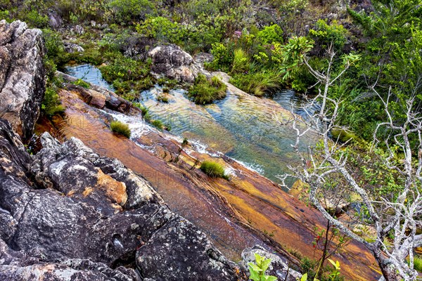 Top view of the cascade and water pools of the Biribiri environmental reserve in Diamantina in the state of Minas Gerais with its hills