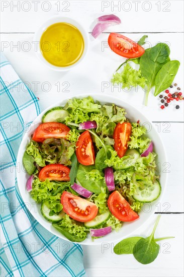 Mixed salad with fresh tomatoes healthy food eating from above on wooden board in Stuttgart