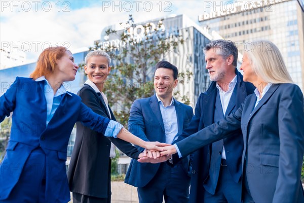 Diverse Group of Senior Executives Celebrate Success with High-Five Gesture