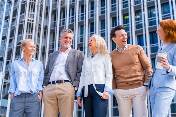 Cheerful group of coworkers outdoors in a corporate office area