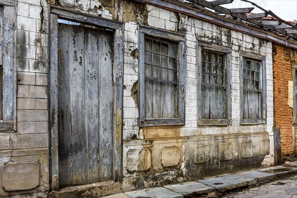 Facade of old abandoned house ruined by time in the city of Diamantina in Minas Gerais