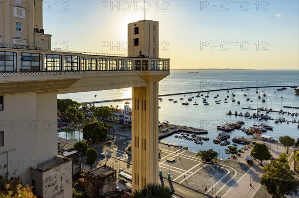 Sunset in the city of Salvador behind the Lacerda elevator with the Bay of All Saints and its boats in the background