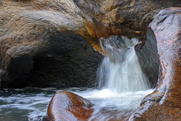 Small creek with clear waters running through the rocks of the mountains of Minas Gerais