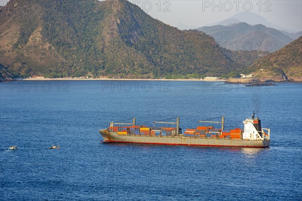 Cargo ship loaded with containers sailing in the sea waters of Guanabara Bay in Rio de Janeiro