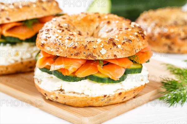 Bagel sandwich for breakfast topped with salmon fish on a board in Stuttgart