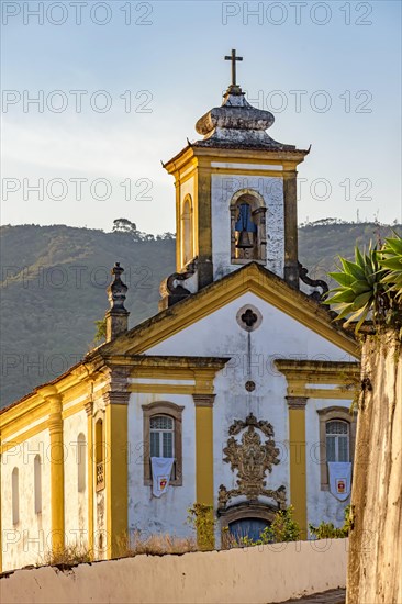 Facade of a historic church in baroque style in the city of Ouro Preto in Minas Gerais during the late afternoon