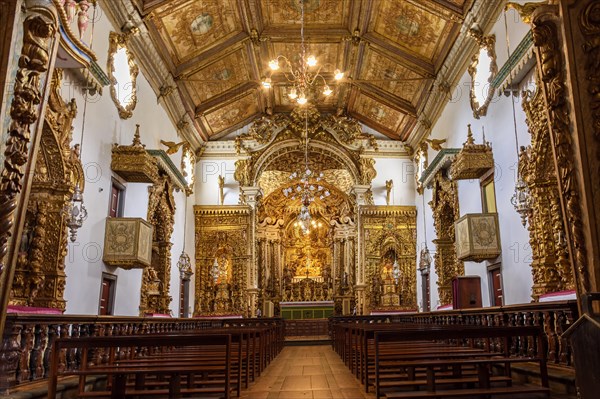 Interior and altar of historic church all painted in gold with baroque architecture in the old city of Tiradentes in Minas Gerais state