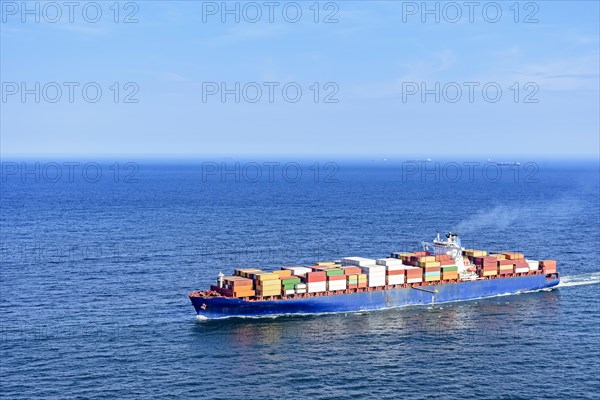 Cargo ship carrying several containers on the waters of the blue sea of rio de Janeiro