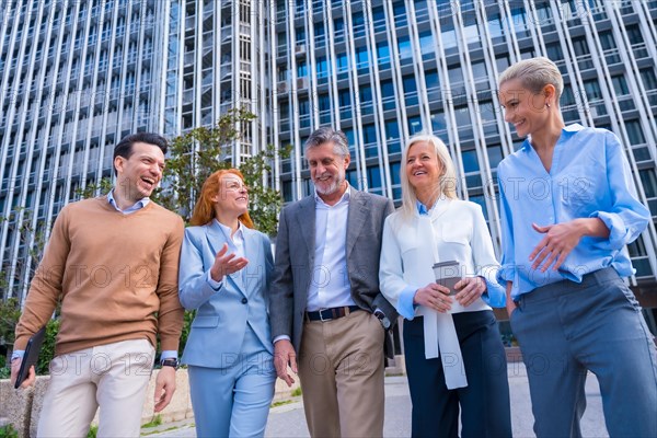 Group of coworkers walking going to work outdoors in a corporate office area