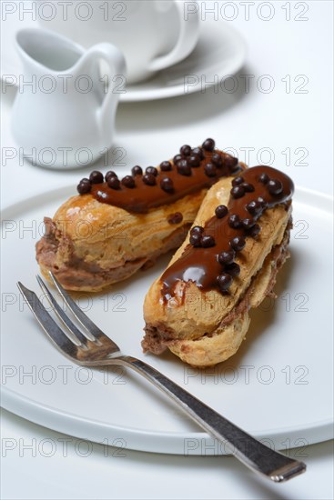 Two chocolate eclairs on a plate