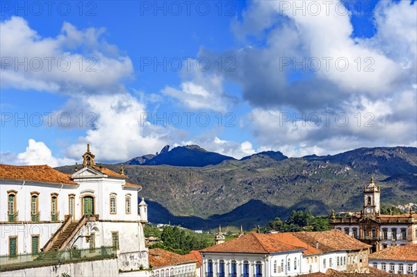 Historic buildings and baroque churches in the city of Ouro Preto in Minas Gerais with the mountains behind the city