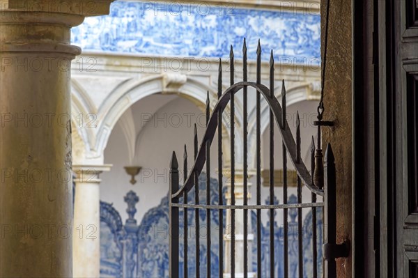 Arches and gate in the inner courtyard of an old historic convent in the city of Salvador