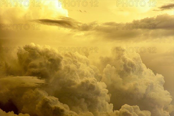 Large rain clouds in the sky illuminated by the sunset