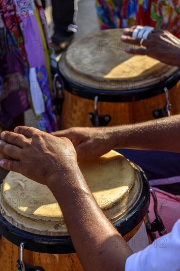 Percussionist playing atabaque during folk samba performance on the streets of Rio de Janeiro