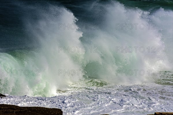 Wave crashing against rocks during storm day at Ipanema beach