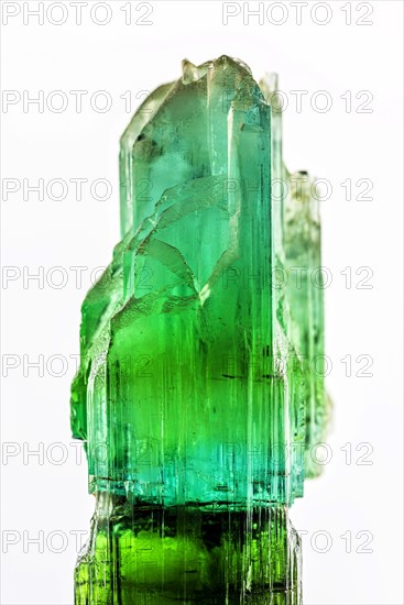 Brazilian crude green tourmaline crystal with white background