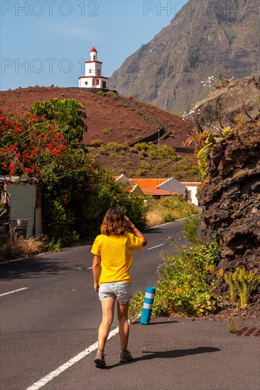 Woman tourist visiting the Joapira bell tower above the parish church of Nuestra Senora de Candelaria in La Frontera on El Hierro