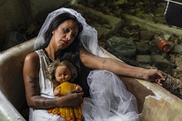 Deranged bride with a doll in a bathtub. Inspired by the traditional American legend of la llorona