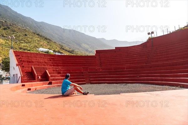 A tourist visiting the amphitheater next to the Nuestra Senora de Candelaria church in La Frontera on El Hierro