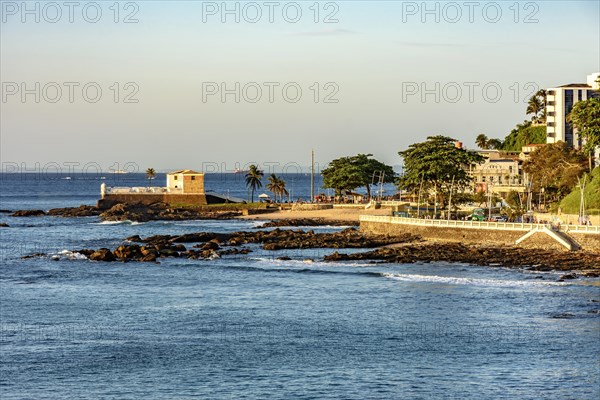 Seafront of the city of Salvador in Bahia with its buildings and the old fort of Santa Maria during the afternoon