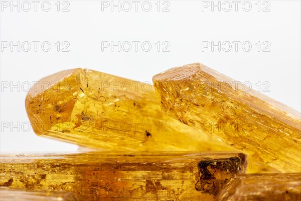 Studio photography of some Brazilian imperial topaz in raw state with white background