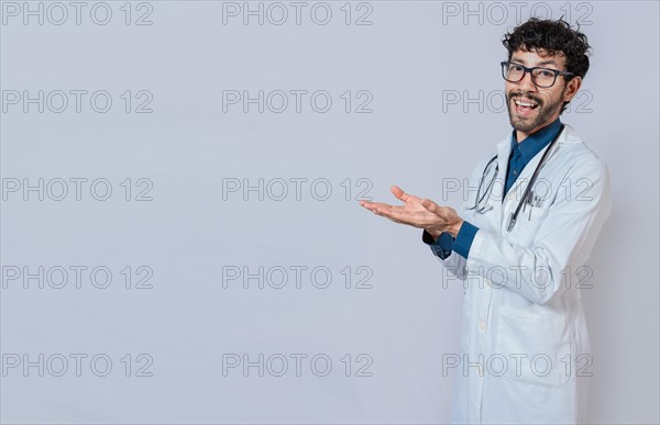 Handsome doctor showing an advertisement with his palms