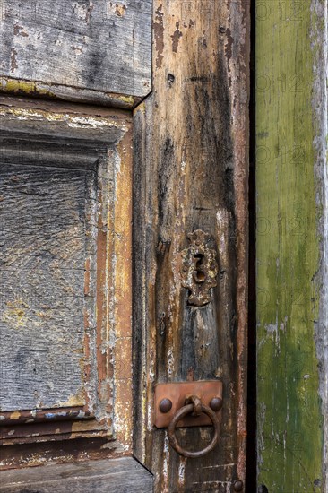 Detail of antique wooden door and lock deteriorated by time and rust in a colonial style house in the historic city of Diamantina in Minas Gerais