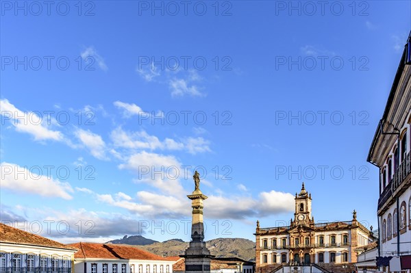 Ouro Preto central square with its historic colonial-style buildings and mountains lit by the late afternoon sun