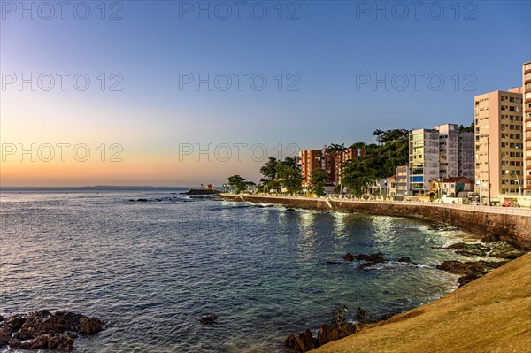 Seafront in the tourist region of the city of Salvador in Bahia during sunset with the sea