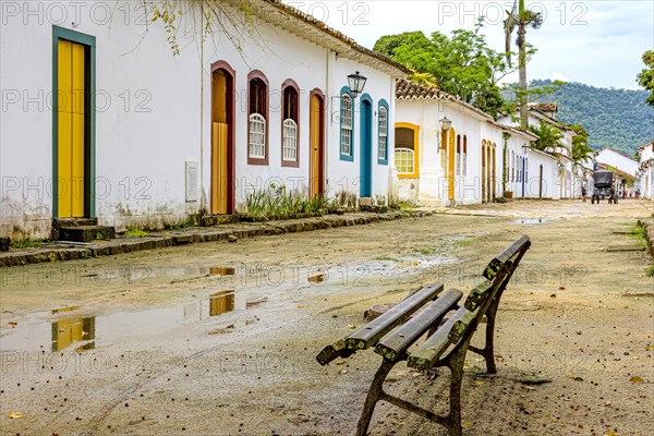 Dirt street wet by rain and colonial-style houses in the old and historic city of Paraty