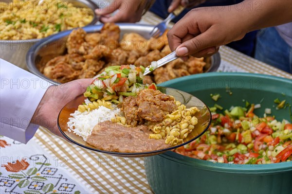 Simple and traditional Brazilian food being served in a popular restaurant for the local low-income population.