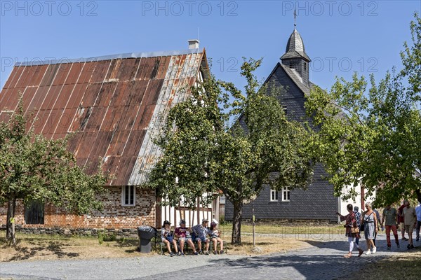 People in front of historic half-timbered houses from Mademuehlen and Muenchhausen