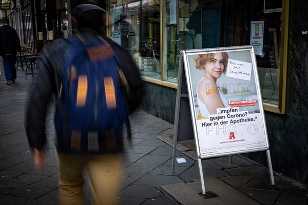 A poster at a pharmacy advertises the possibility to get vaccinated at pharmacies in Duesseldorf