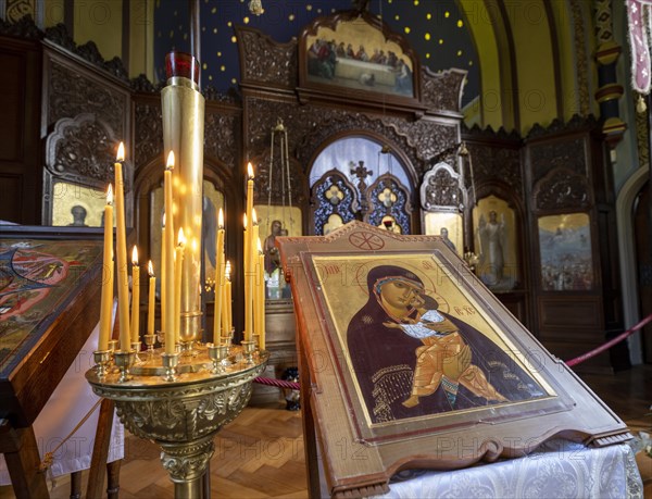 Burning candles next to an icon in the Russian Chapel