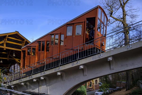 A renovated car of the upper Heidelberg mountain railway leaves the Molkenkur station on the Kleiner Gaisberg towards the Koenigstuhl