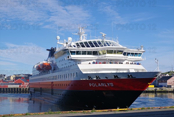 A Hurtigruten ship turns in the harbour of the town of Vardoe