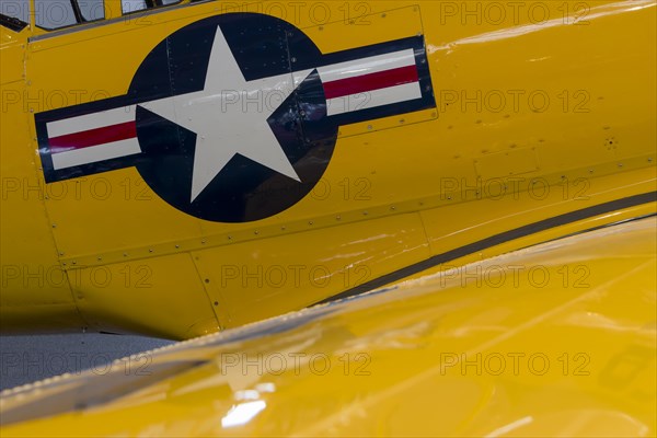 Navy tail on a yellow fighter plane classic car