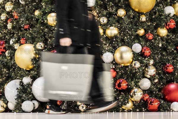 People stand out against Christmas decorations in a shopping centre on Schlossstrasse in Berlin