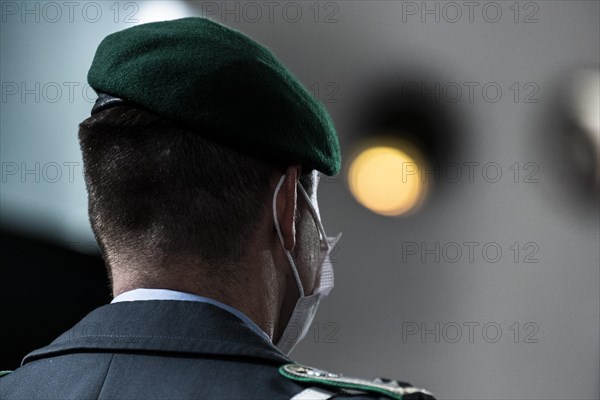 A soldier of the German Armed Forces wearing mouth-nose protection