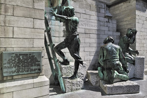 Sculpture group showing medieval labourers and stone carvers in front of the Cathedral of Our Lady in Antwerp