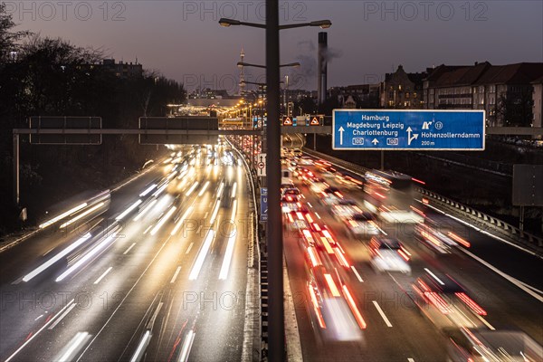 Congested traffic on the A100 looms at blue hour in Berlin