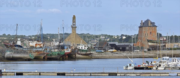 The fortification Tour Vauban and wrecks of small trawler fishing boats in the harbour of Camaret-sur-Mer