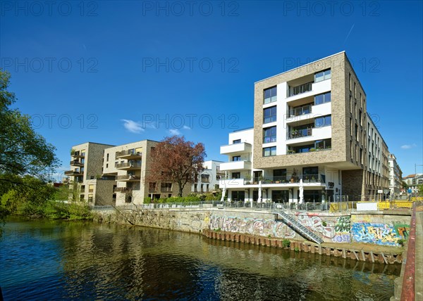 Modern residential buildings on the river Weisse Elster