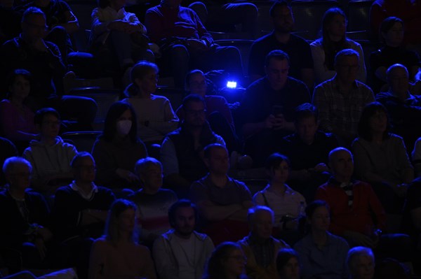 Spectators in blue light