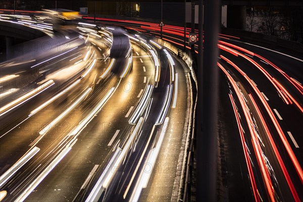 Congested traffic on the A100 looms at blue hour in Berlin