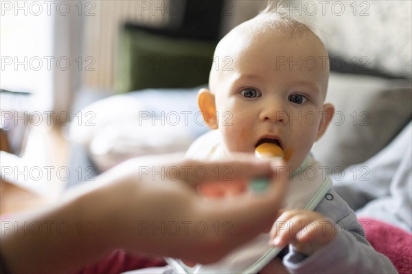 Child is fed with porridge