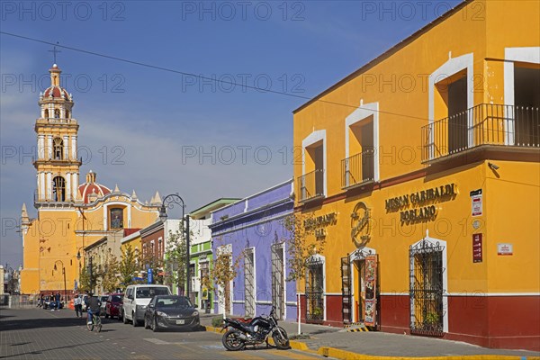 Colourful street with restaurants and parish church for the San Pedro municipality along the Plaza de la Concordia