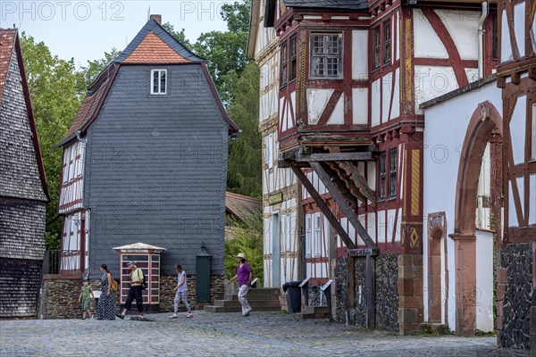 People in a street with historic half-timbered houses